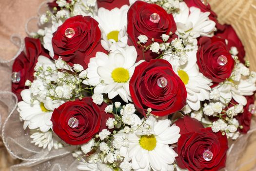 Bride's bouquet of red roses and white daisies