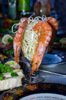 King prawns in a glass with cheese. Table setting