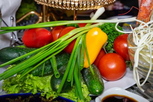 Fresh vegetables on a plate. Vegetarian food. Tomatoes, cucumbers, onions, parsley