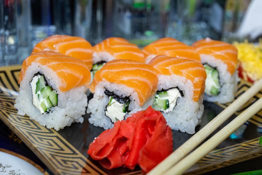 Sushi with red fish. Sushi plate, wasabi and sushi sticks