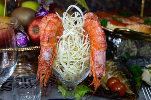 King prawns in a glass with cheese. Table setting