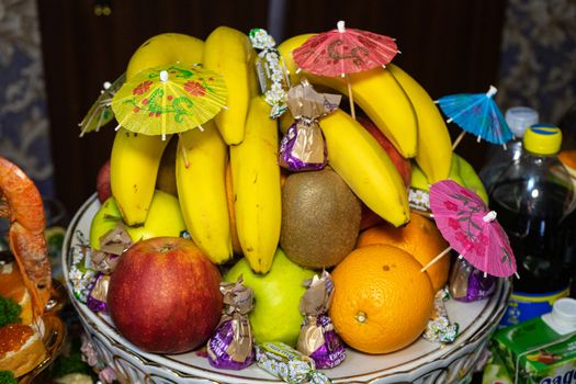 Ukraine, Vinnytsia - May 23, 2020. Fruits and candies on a plate.