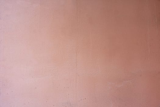 old concrete wall painted in light burgundy color