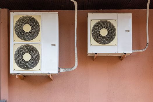 old white air conditioners attached to the wall