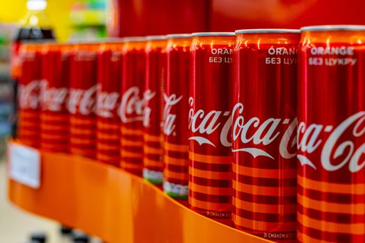 Ukraine, Vinnytsia, 2020 May 25 - Many red iron jars of Coca Cola stand in a shop window