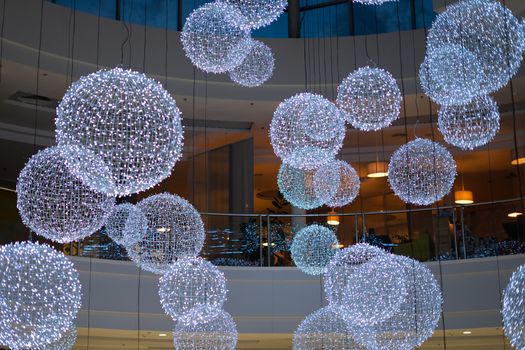 big bright balls with garlands. balls with white lights. decorations in the mall