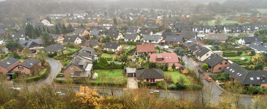 Suburb in Germany. Aerial view of single-family houses, gardens and streets, aerial view of the drone from a height of 50 metres.