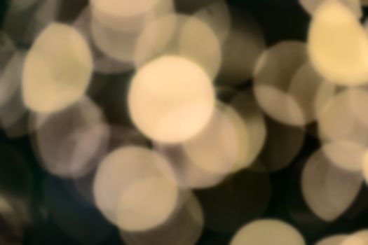 Bokeh of blurred electric candles on a christmas tree, zoomed in
