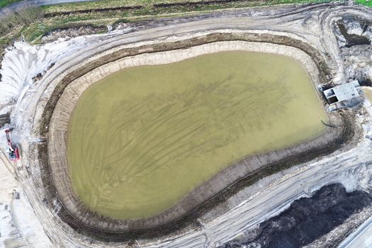 Aerial view of the rainwater retention basin under construction in a new development area, subsidence law survey, taken with a drone