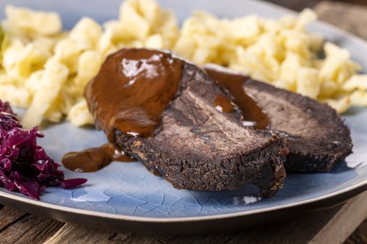 closeup of a german sauerbraten with dumplings