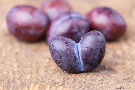 heart shape plum on dark wood