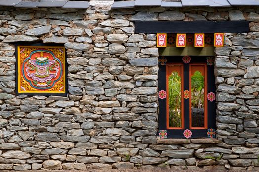 Colorful Tibetan window on the rock wall in Tibet, China