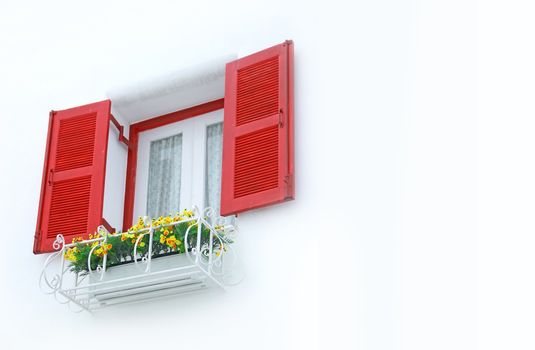 outer opened red and white inner closed window with white wall decorated with flowerpod