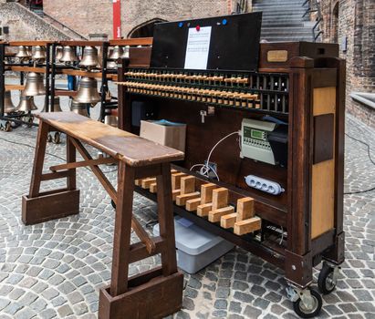 Bruges, Flanders, Belgium -  June 15, 2019: The brains and central part of the electronic Carillon with keyboard, pedals and batons on the square inside the Belfry.