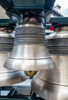 Bruges, Flanders, Belgium -  June 15, 2019: Closeup of one heavy metal and shiny Petit and Fritsen bell of carillon on square inside Belfry.