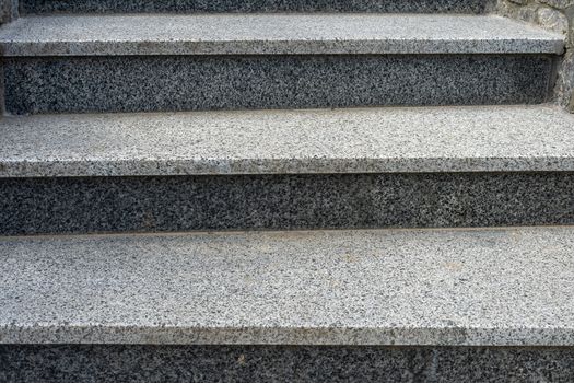 Gray granite stairs. Artificial granite. Three steps