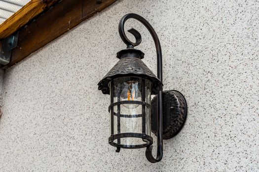 Lamp in vintage style. The lamp is attached to the wall. The lamp is black