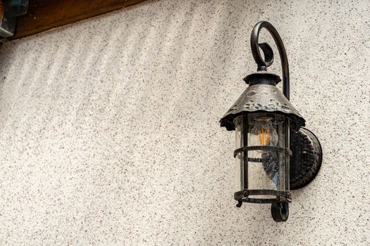 Lamp in vintage style. The lamp is attached to the wall. The lamp is black