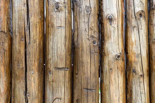 Background from a tree. Wooden fence. Fence made of wooden boards