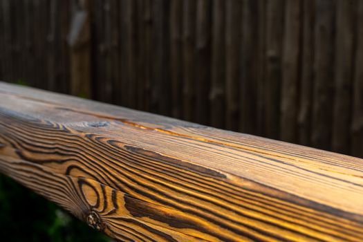 Wooden products. Wooden beam. Wooden railings near the stairs close up. Blurred background. Soft focus