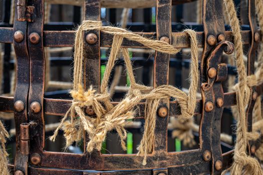 Part of the cage made in vintage style close up. Metal mesh and rope