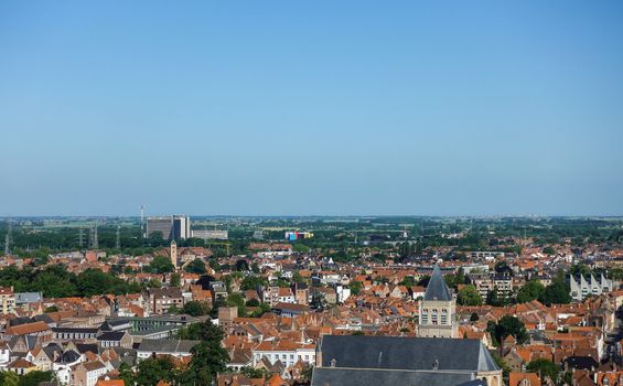 Bruges, Flanders, Belgium -  June 17, 2019: View North from top of Belfry tower, Halletoren, towards new AZ Sint Jan. Red roofs, large highrise block of the clinic, North Sea and flat country.