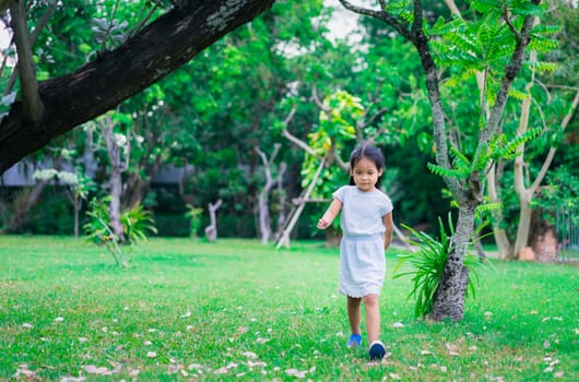 Cute asian little girl walking in the park