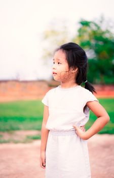 portrait of cute little girl standing in the park