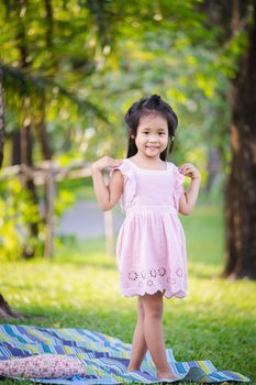 portrait of cute little girl standing in the park