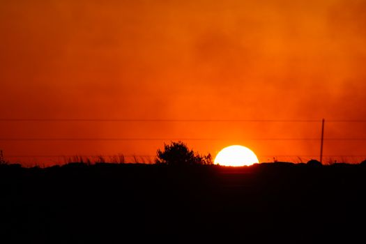 Cloudy orange sunset over a countryside horizon, Pretoria, South Africa