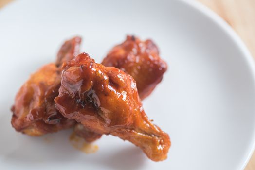 spicy BBQ chicken wing in white plate