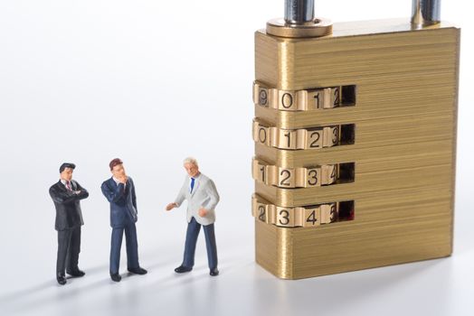 business miniature people try to unlock security lock key