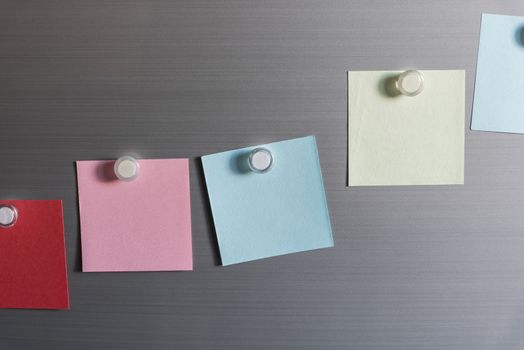colorful magnet sticky notes on refrigerator door background