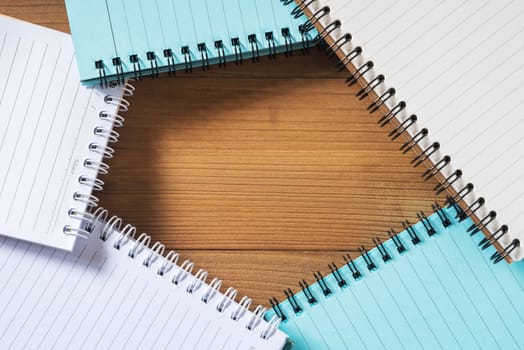 blank notebook on brown wood table