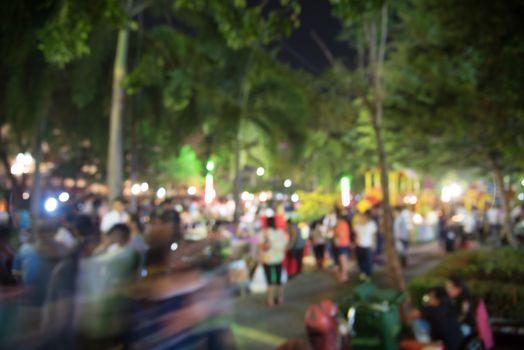 abstract blurred people at night market  festival