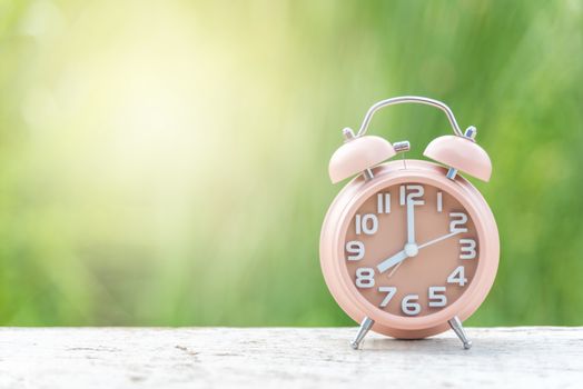 green clock on white wood and green natural background