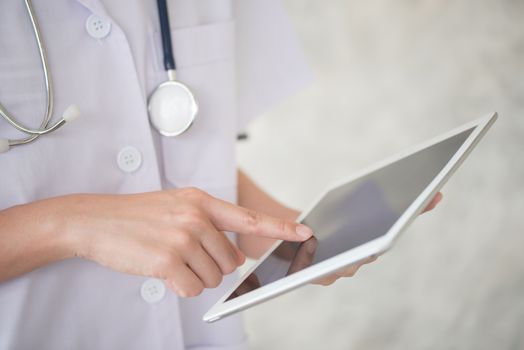 woman doctor finger touch on tablet screen