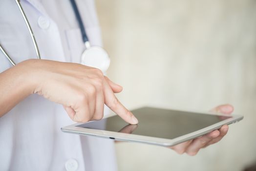 woman doctor finger touch on tablet screen