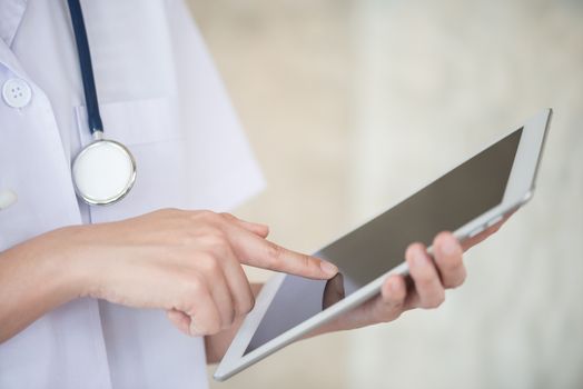 woman doctor using tablet