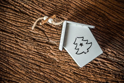 white christmas tree house on grnage wooden background