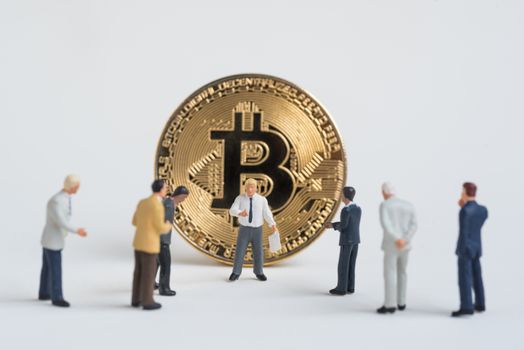 business miniature man present Cryptocurrency golden bitcoin ,digital currency