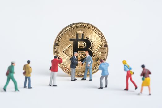 business miniature man shaking hand accept Cryptocurrency golden bitcoin ,digital currency