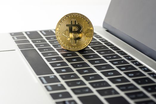Cryptocurrency golden bitcoin on laptop computer, digital currency concept
