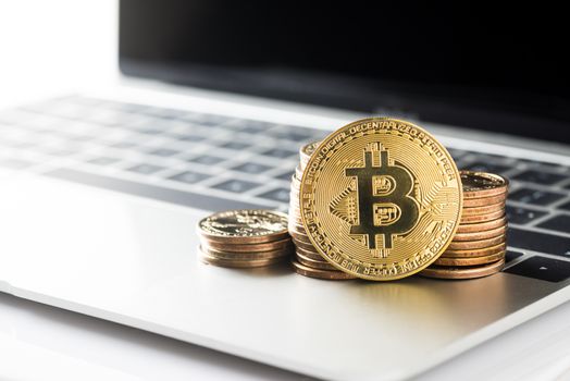 Cryptocurrency golden bitcoin and dollars money on laptop computer, digital currency concept