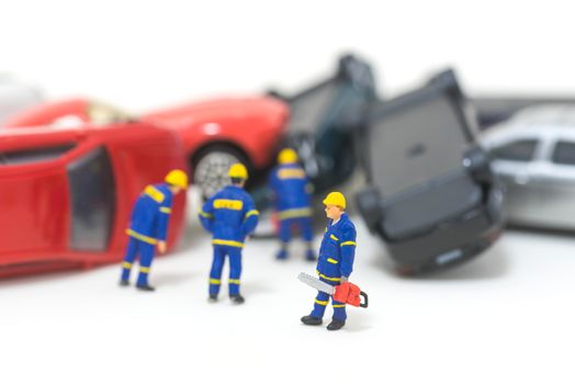 miniature rescue team are removing car crash from the road isolated on white background