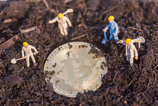 miniature worker people found gold bitcoin in soil agricultural plots field