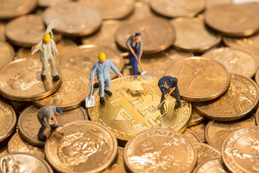 miniature figure people working on Cryptocurrency golden bitcoin and dollars coin money