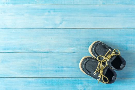 kids fashion shoes on light blue wood plank background