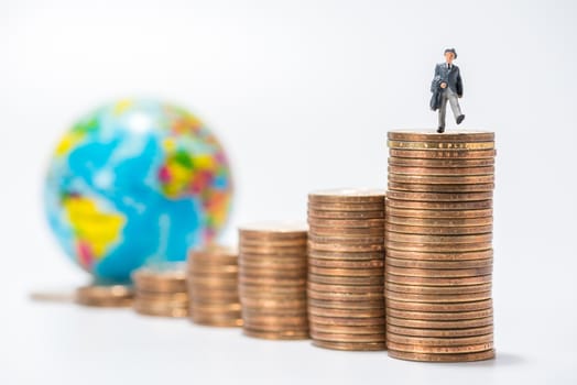 business miniature figure standing on stack of coins and globe figure background