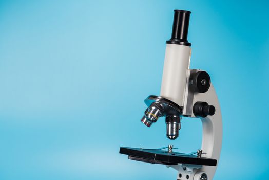 science microscope on light blue background